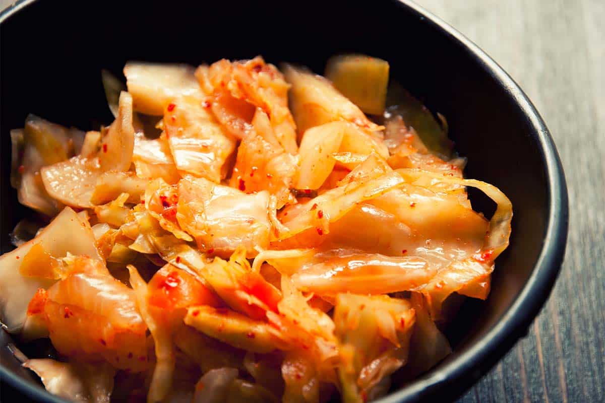 black bowl filled with the results of a Paleo Kimchi Recipe
